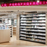 Photographie de la parapharmacie disponible au niveau -1 des Galeries Lafayette Haussmann. Elle est lumineuse et au design moderne avec une enseigne néon rose.